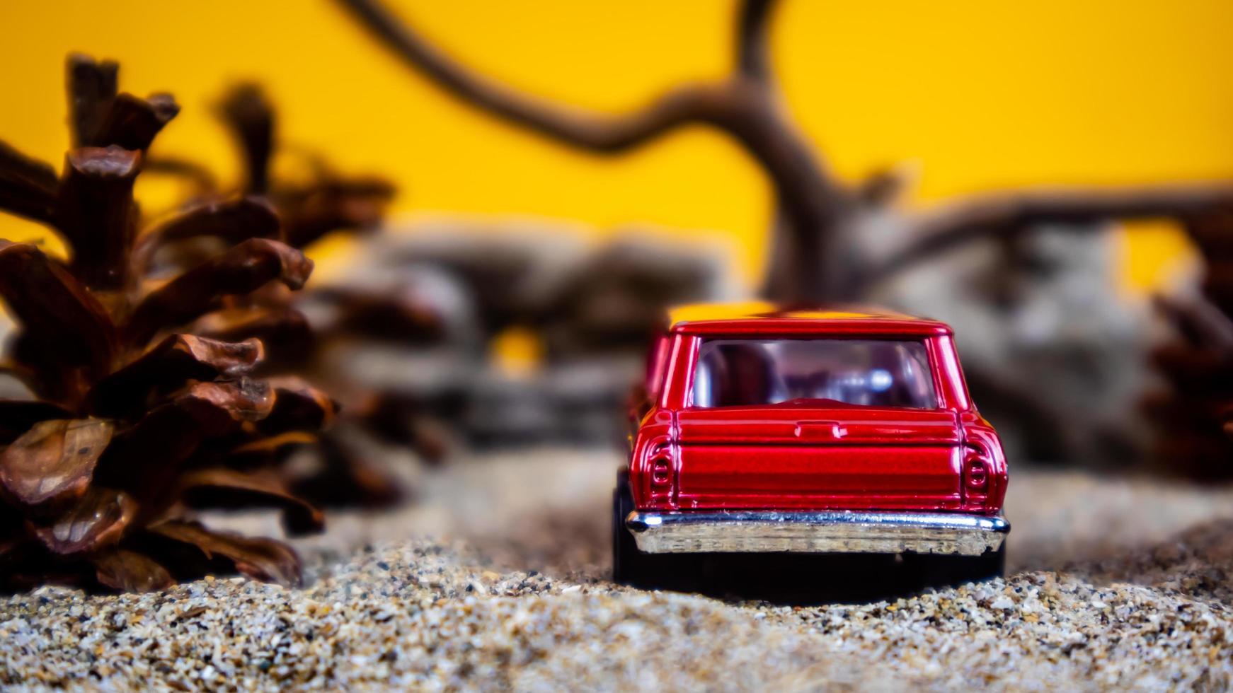 Minahasa, Indonesia saturday, December 2022, a toy car among the pinecones photo