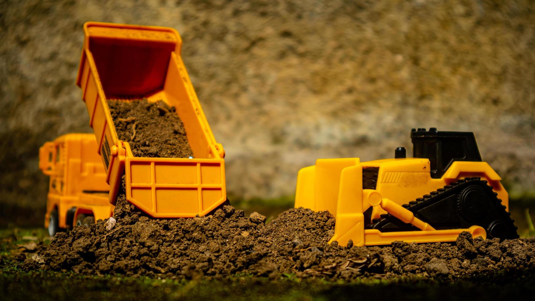 South Minahasa, Indonesia  January 2023, a yellow dump truck toy transporting sand photo