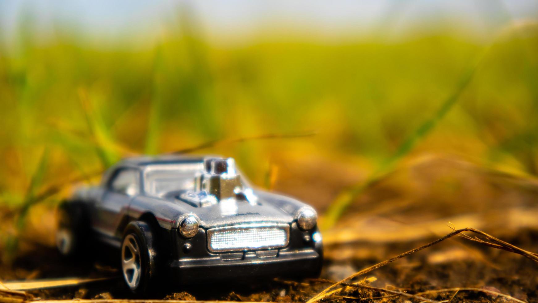 South Minahasa, Indonesia  February 2023, toy car on green grass photo