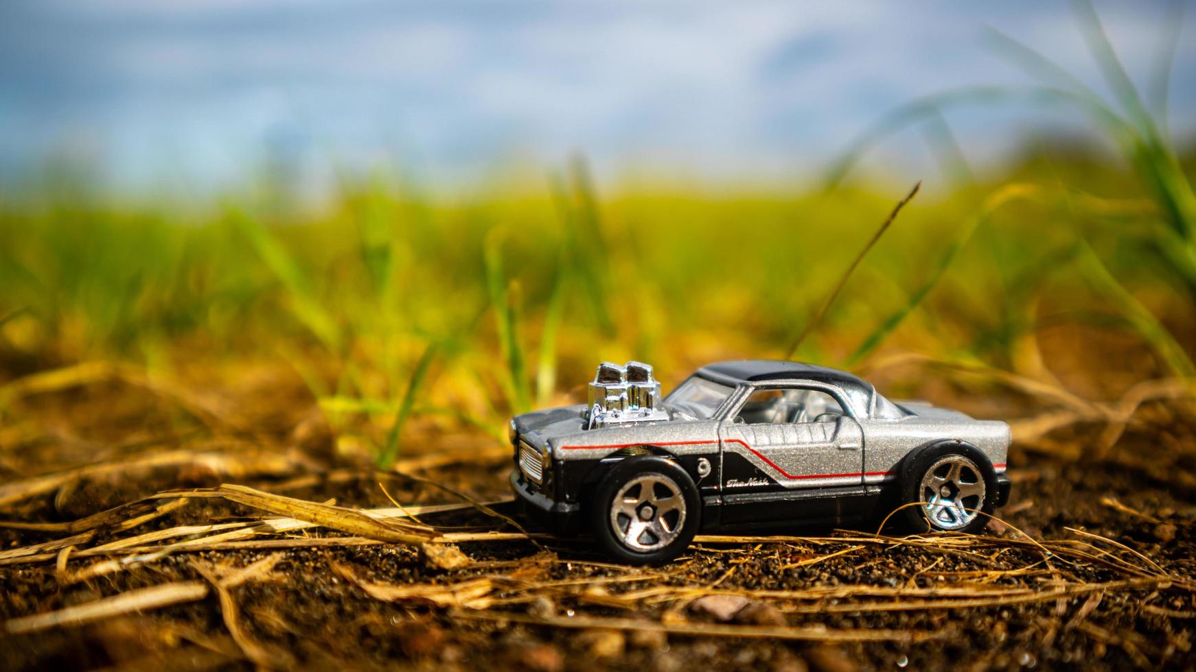 South Minahasa, Indonesia February 2023, toy car on green grass photo