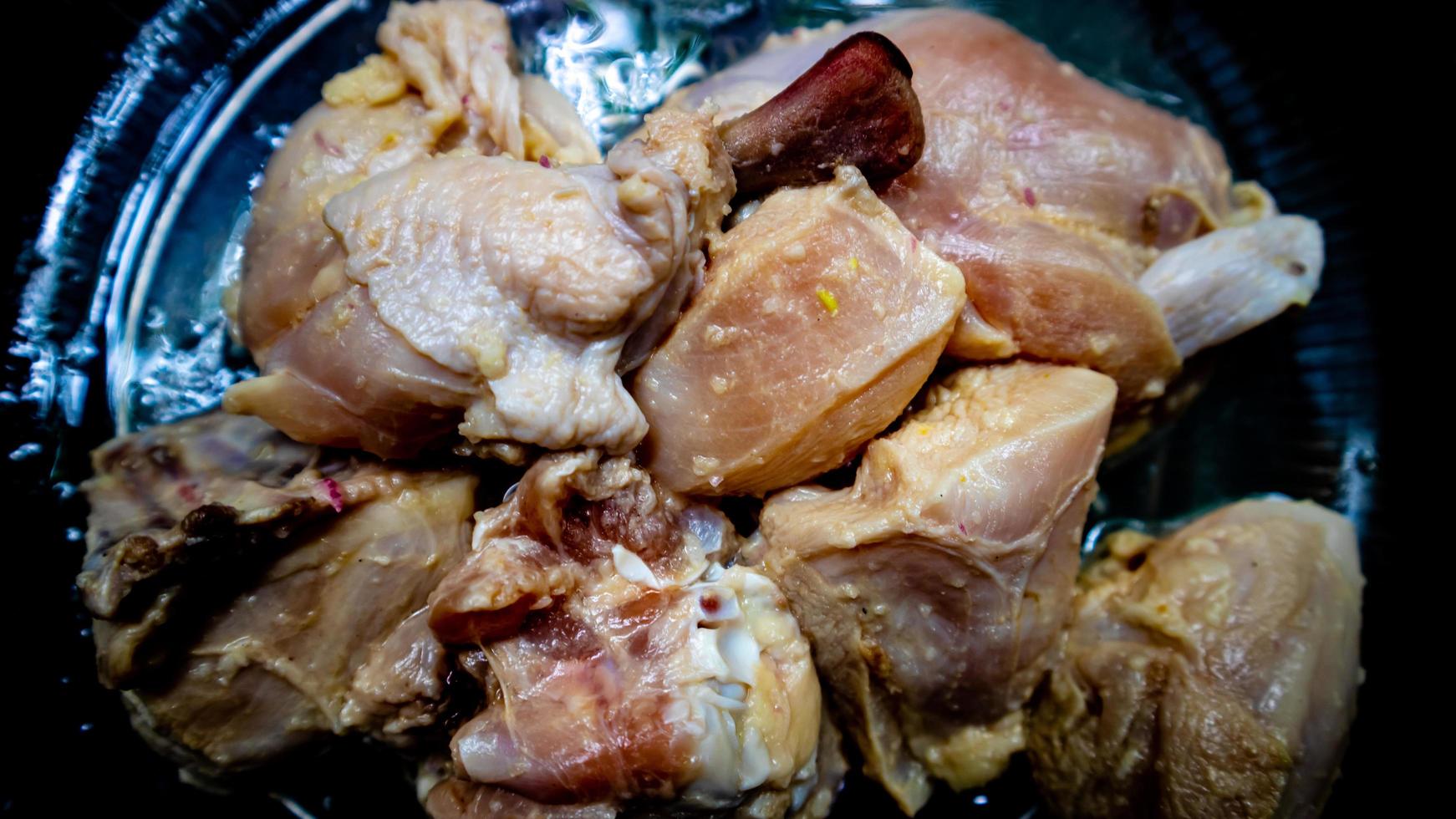 raw chicken on a plate ready to be grilled photo