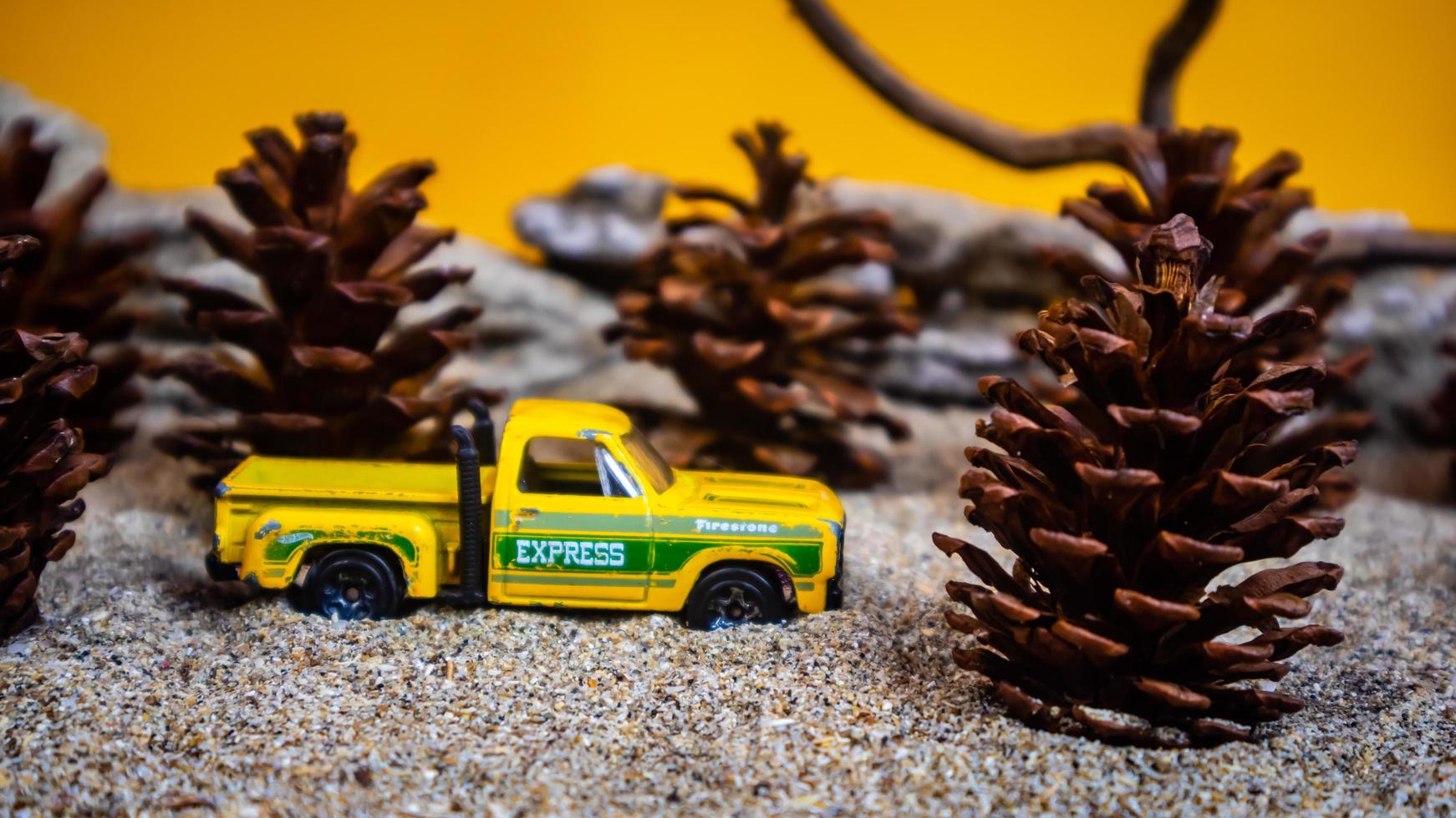 Minahasa, Indonesia  December 2022, the toy car among the pine cones photo