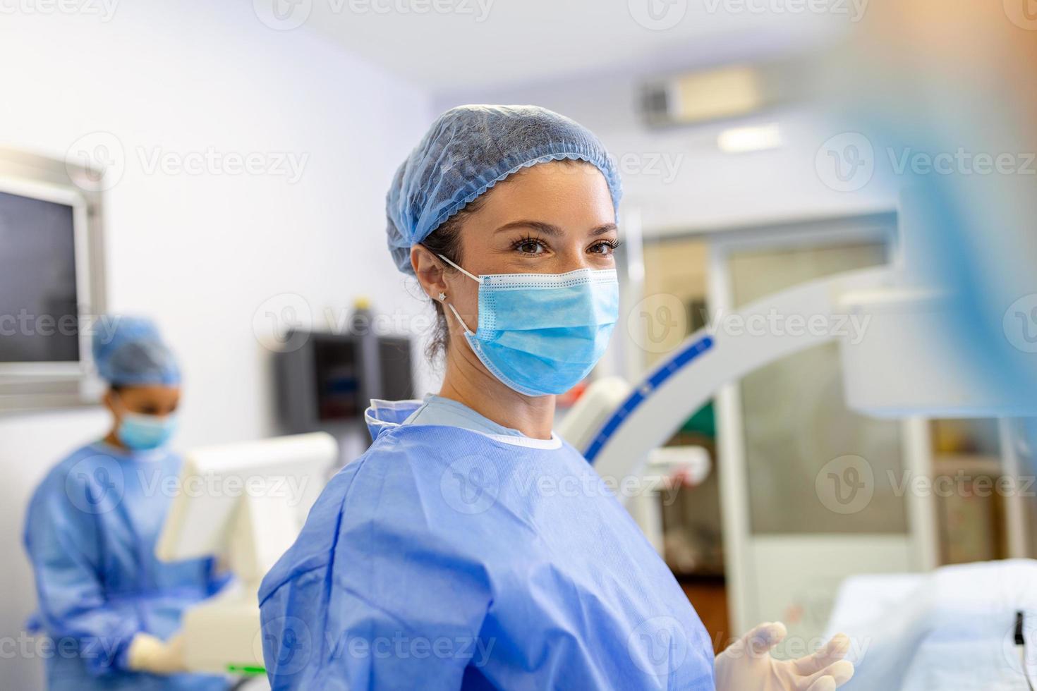 Female surgeon with surgical mask at operating room. Young woman doctor