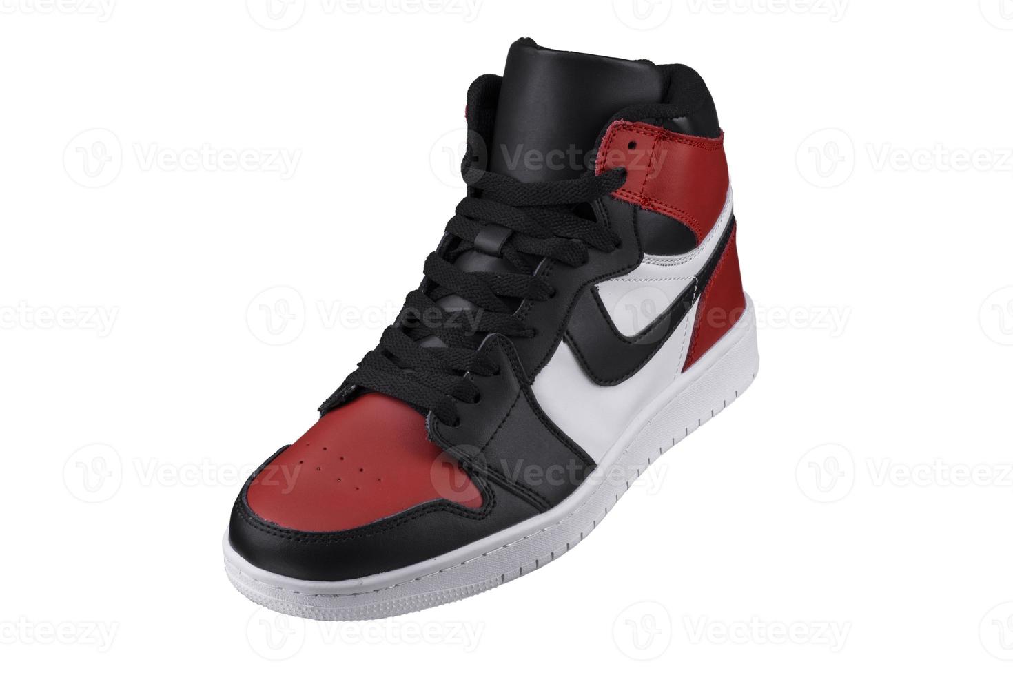 Side view of a high sneaker with red and black accents. photo