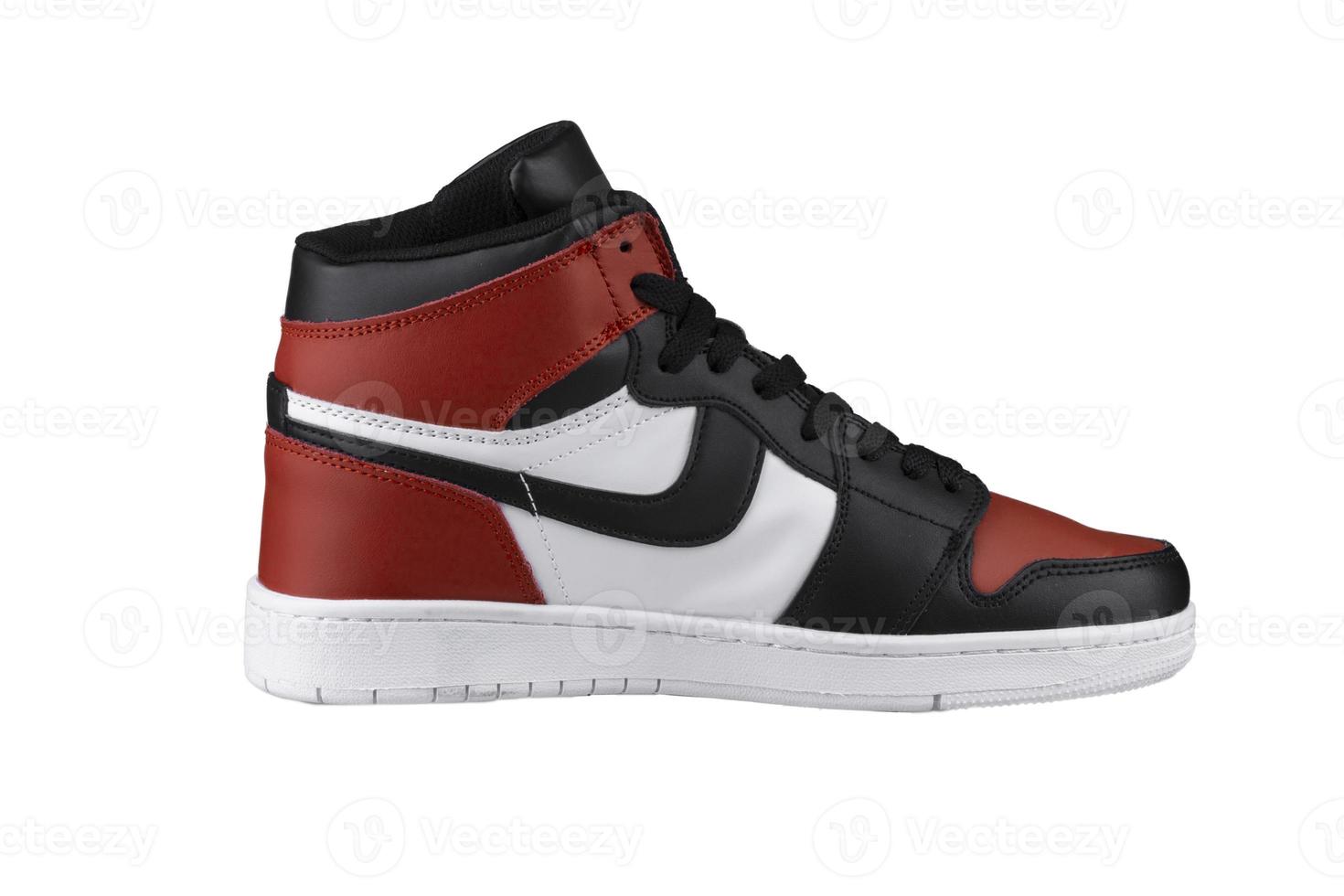 Side view of a high sneaker with red and black accents. photo