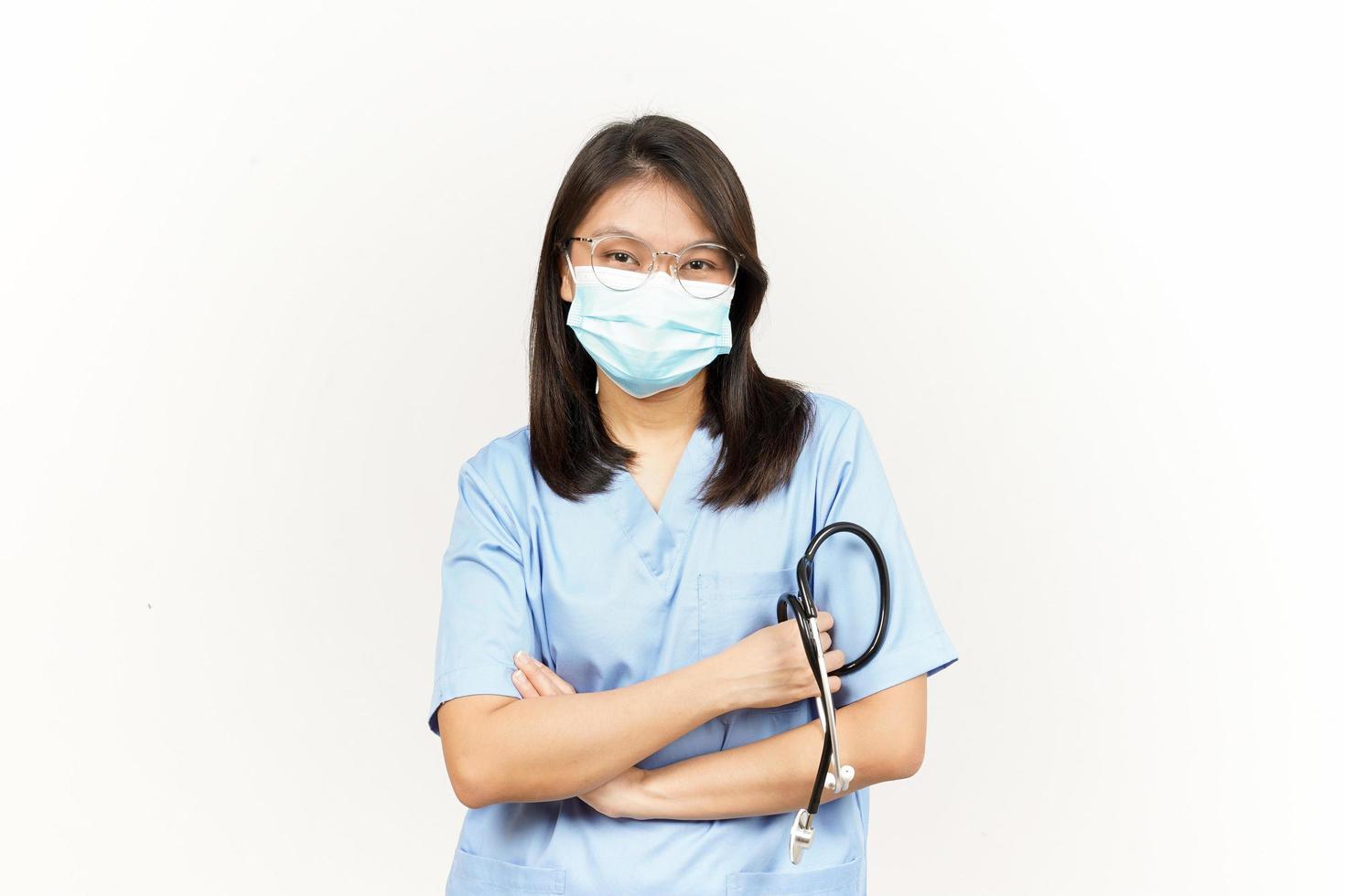 Wearing Mask And Folding Arms Of Asian Young Doctor Isolated On White Background photo