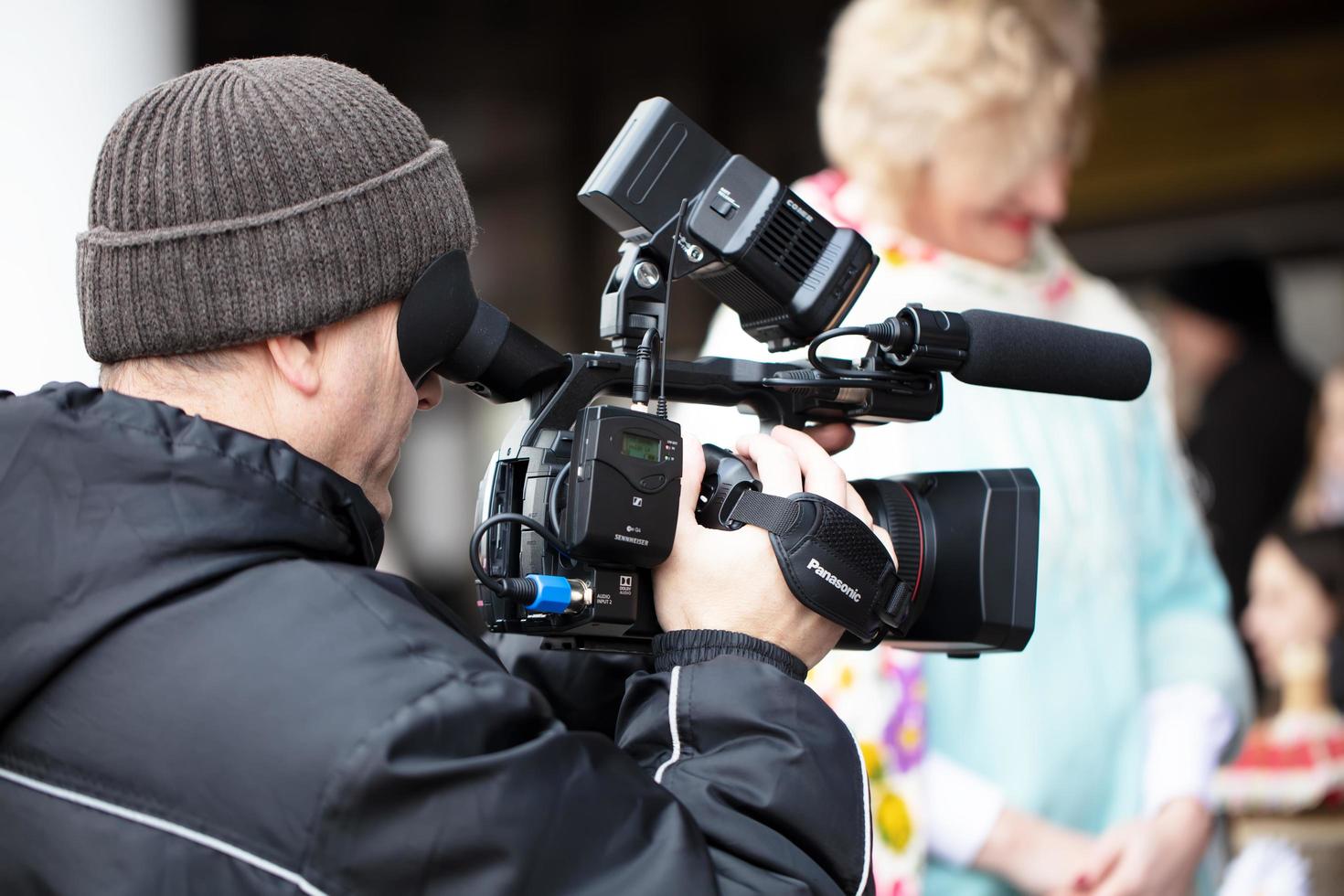 A holiday in the city.Belarus, the city of Gomel, February 29, 2020. Holiday in the city. Videographer at work on the street. Man with a video camera. photo