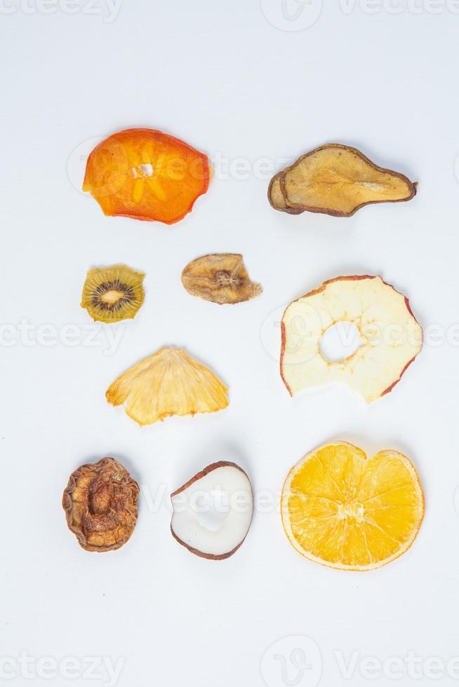 Dried fruits isolated on white background. Healthy eating concept. Top view. Healthy vegetarian food concept. Dried fruit chips. photo