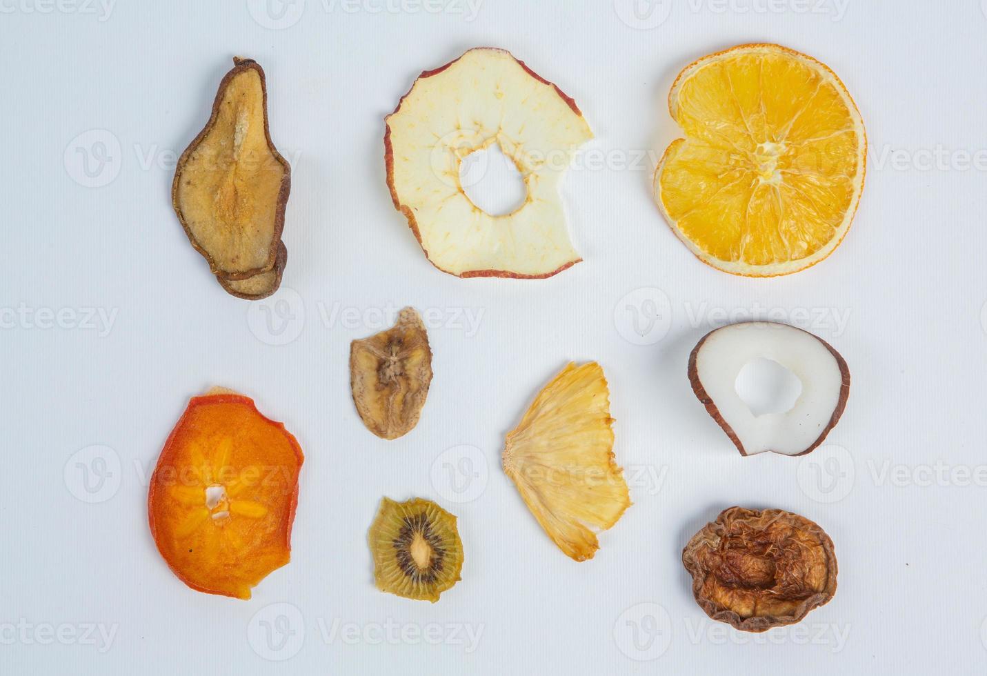 Dried fruits isolated on white background. Healthy eating concept. Top view. Healthy vegetarian food concept. Dried fruit chips. photo