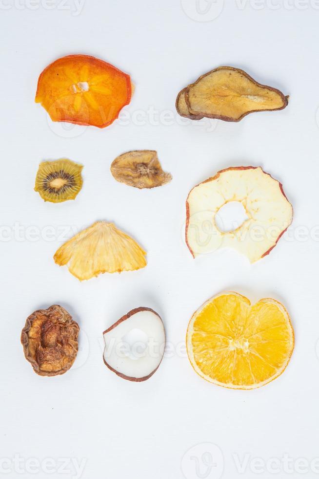 Dried fruits isolated on white background. Healthy eating concept. Top view. Healthy vegetarian food concept. Dried fruit chips. photo