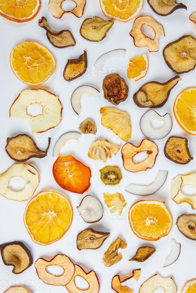 Dried fruits isolated on white background. Healthy eating concept. Top view. Healthy vegetarian food concept. Dried fruit chips. photo