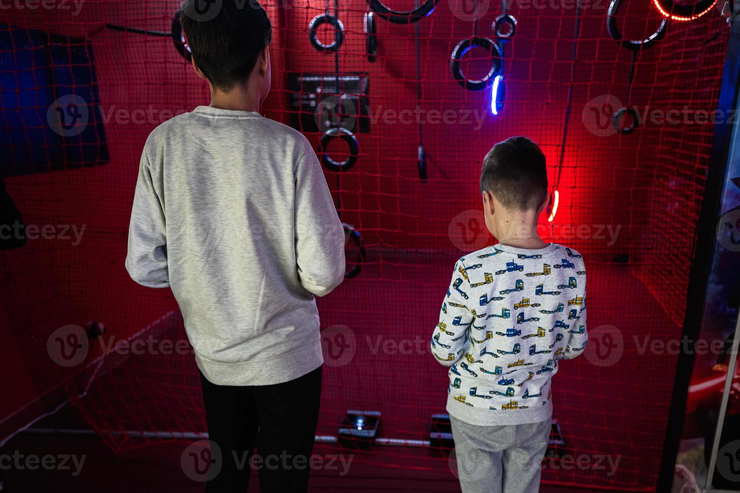 Children flying remote control drones game indoor play zone. photo