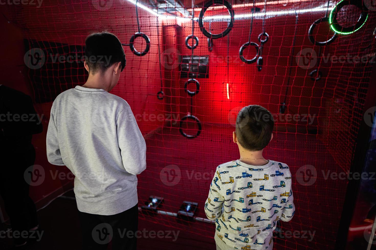 Children flying remote control drones game indoor play zone. photo
