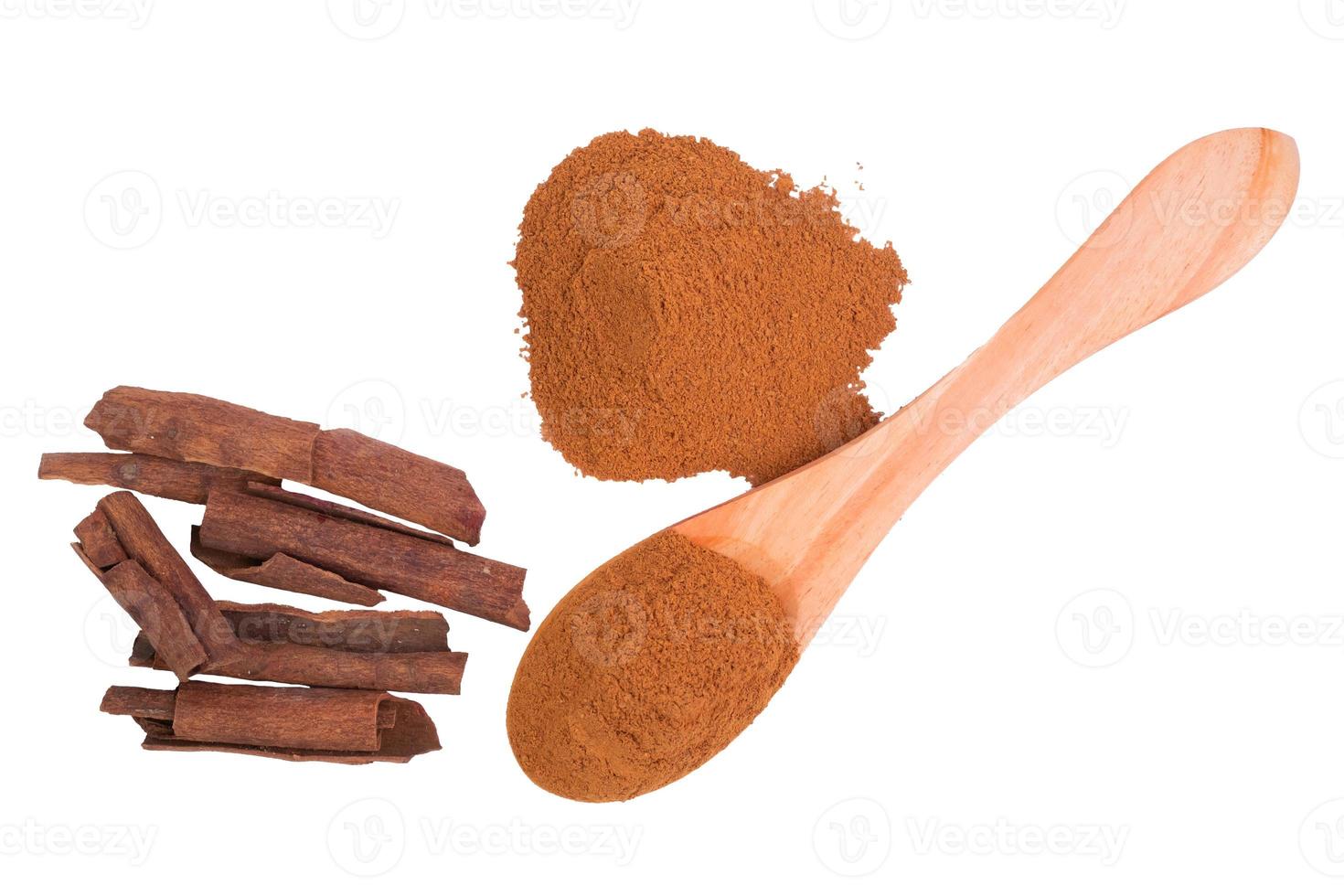 Cinnamon powder with wooden spoon isolated on white background. photo