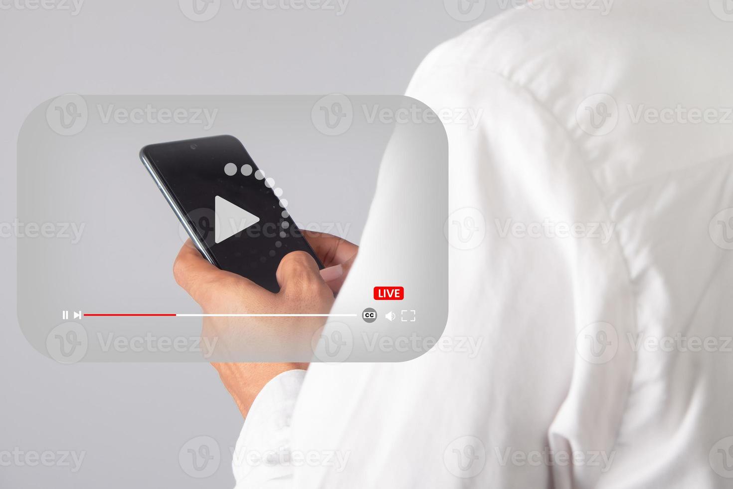 Male hand holding smart phone with video player icon. online live streaming video concept photo