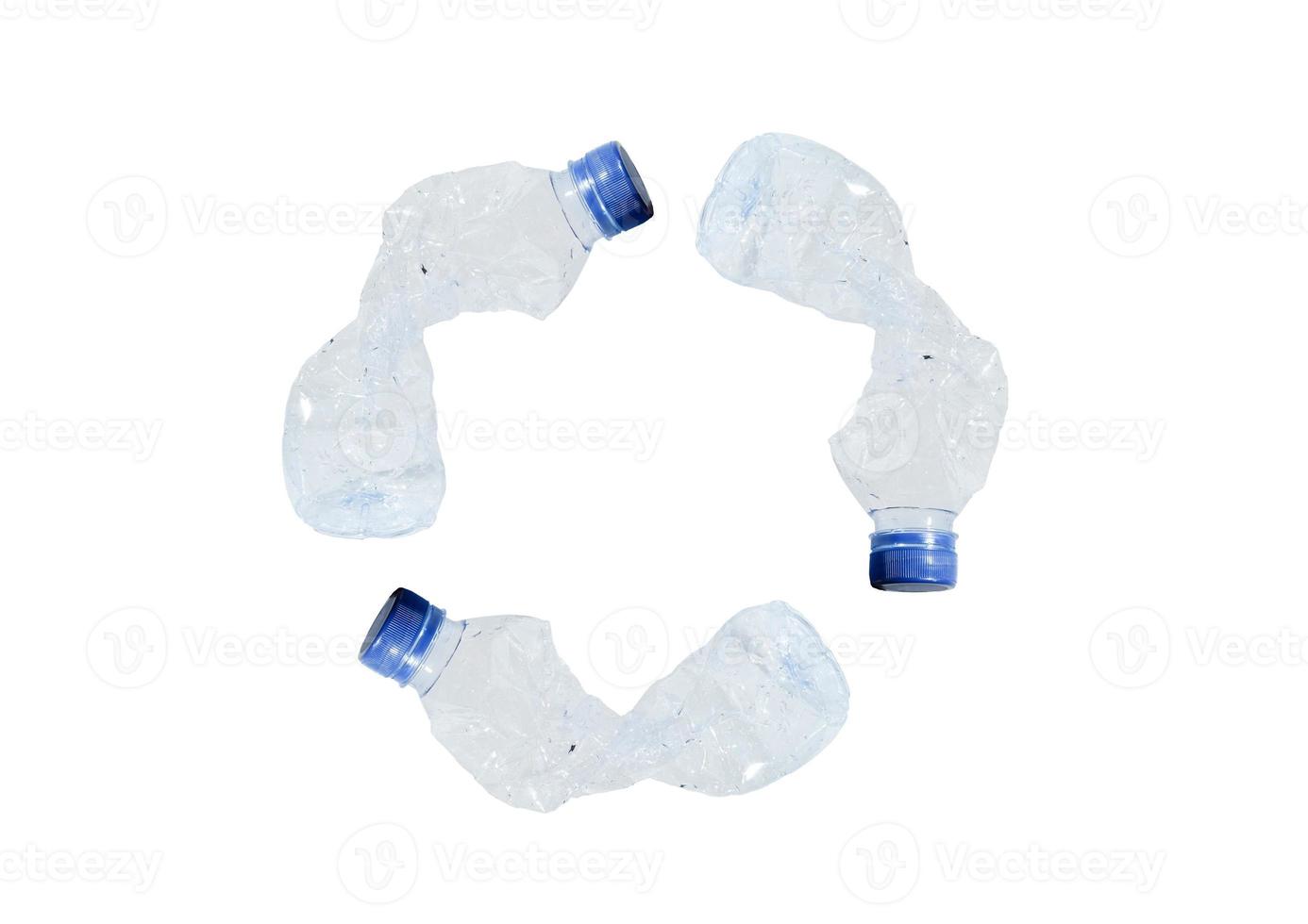 Crumpled plastic bottles forming a recycle sign. The concept of using plastic. Attractive ecological problem positive poster. photo