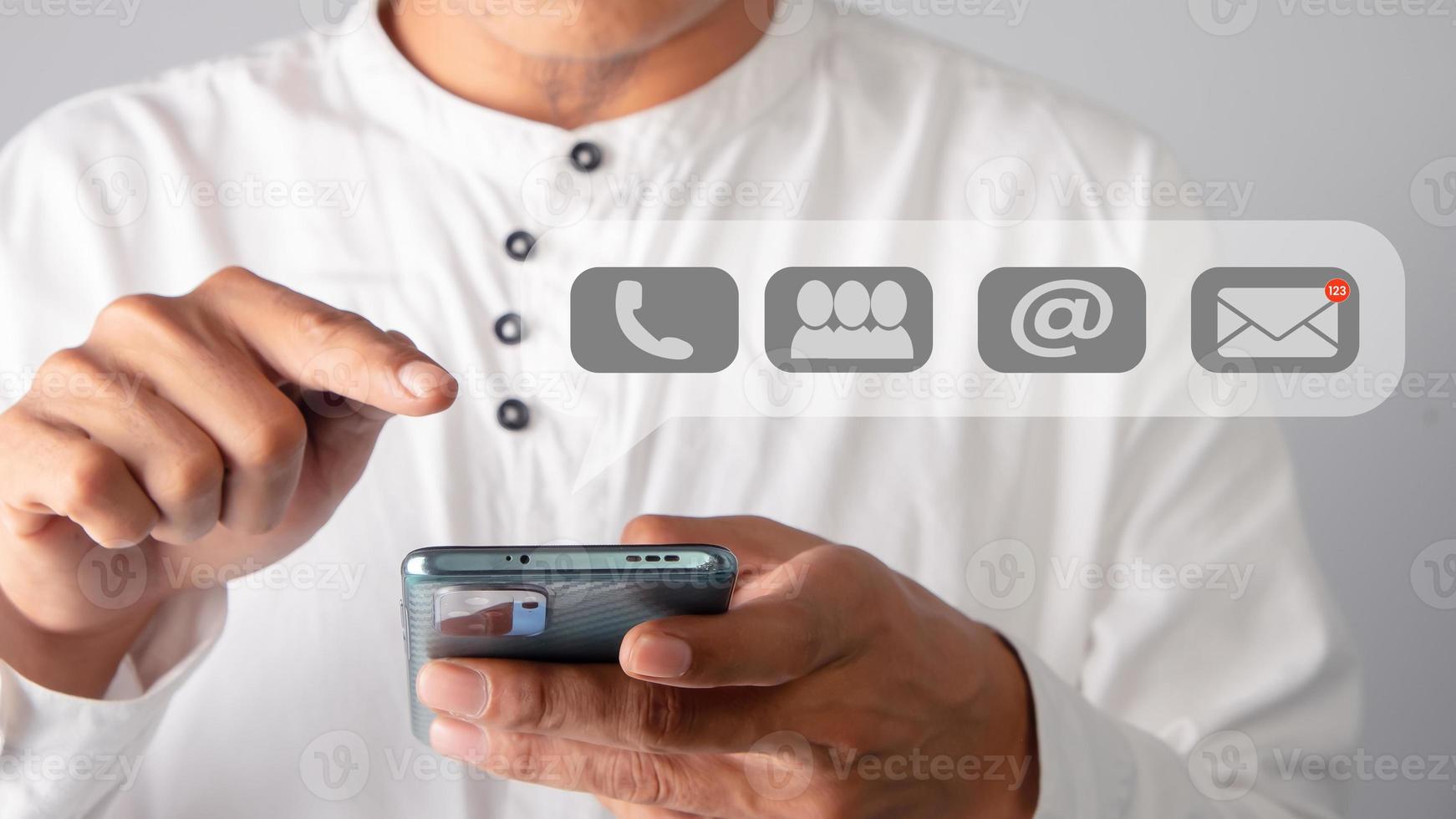 Businessman holding smartphone with a mail icon. Customer Support concept. photo