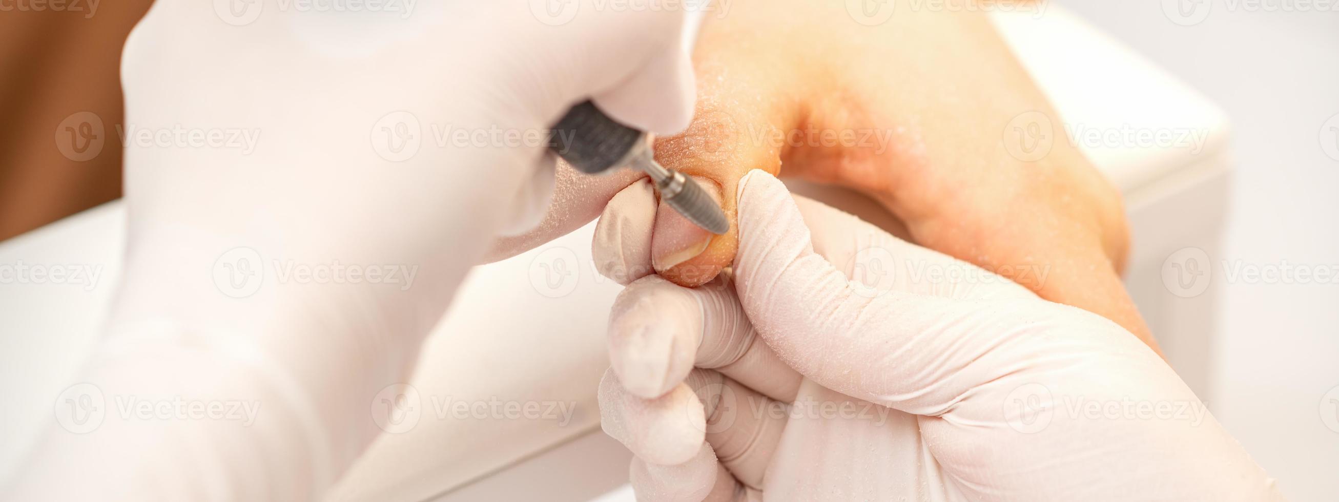 Manicurist removing old nail polish photo