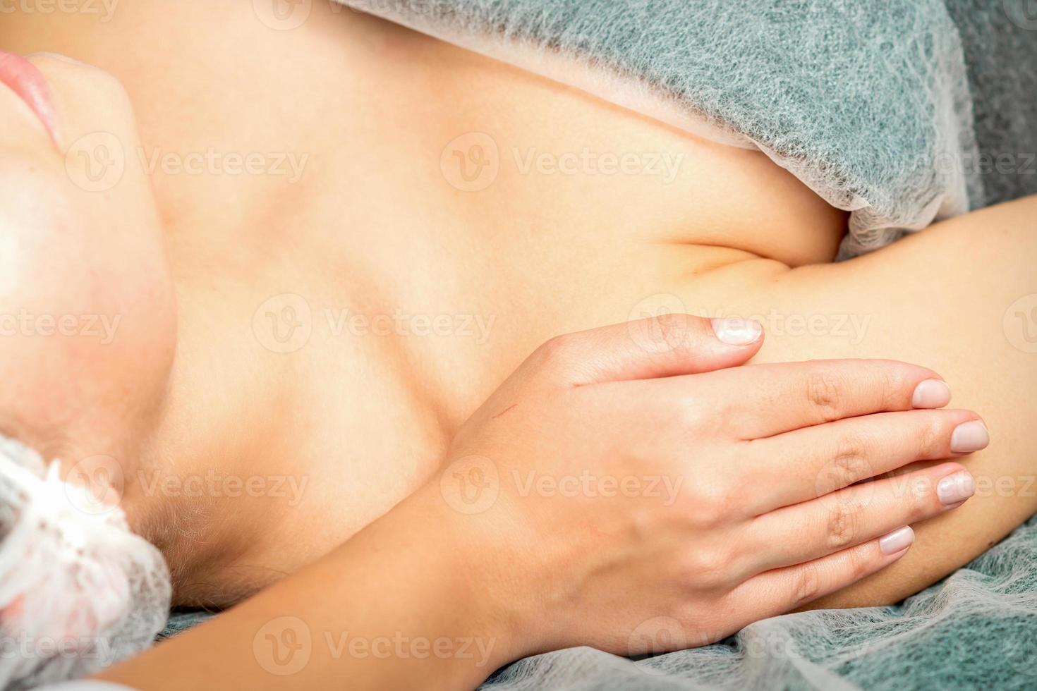 Therapist making massage of shoulders photo