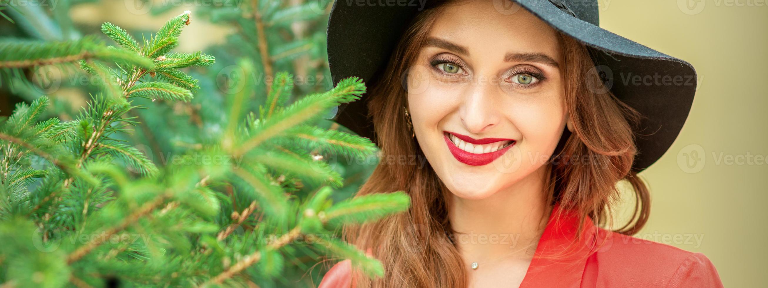 Young woman with Christmas tree photo