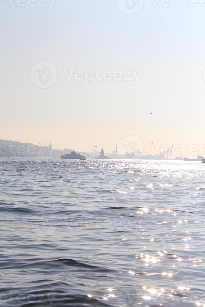 Landscape of the Istanbul bosphorus with ships on it under a cloudy sky in the evening photo