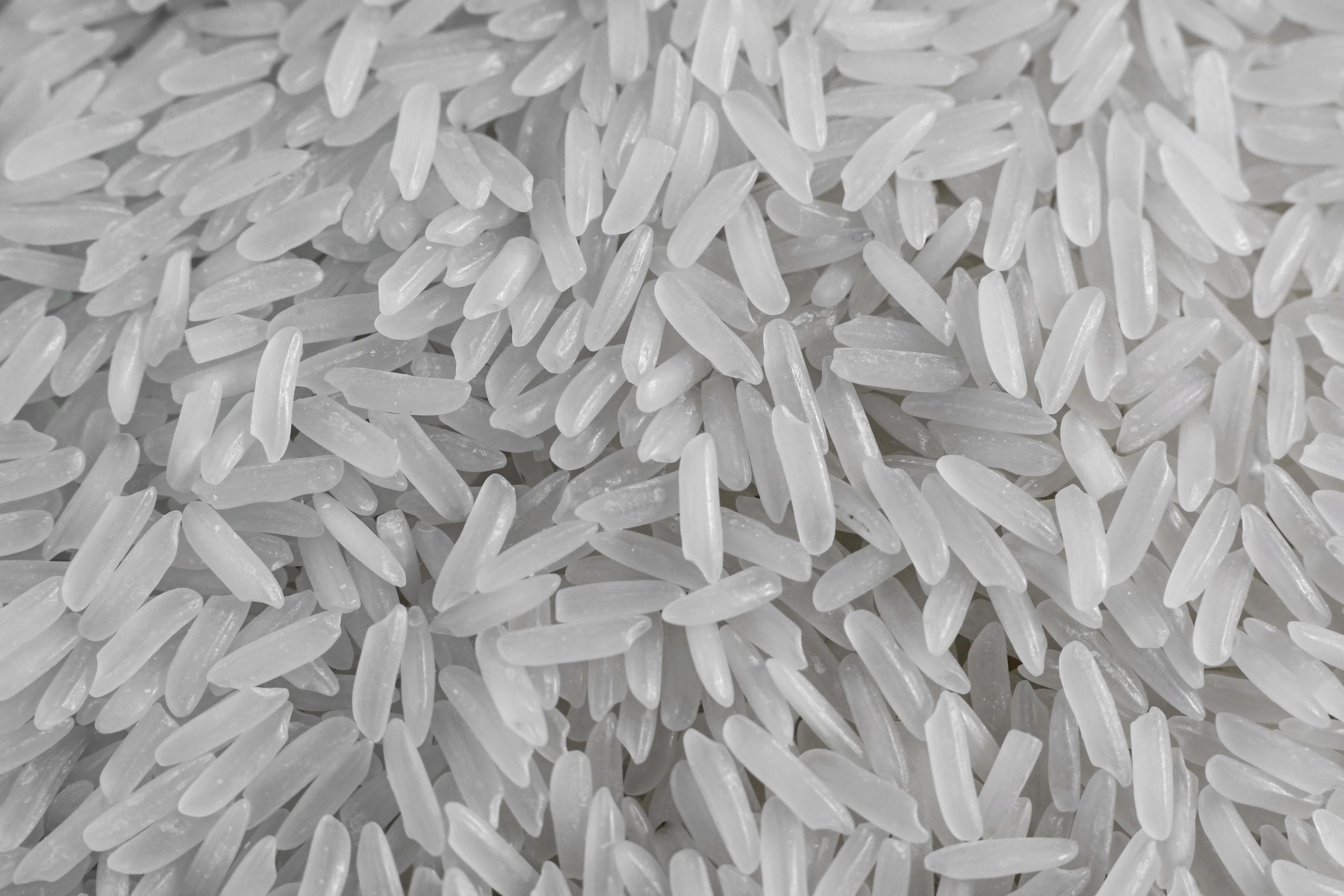 Close up of dry raw white rice background. Macro top view of uncooked