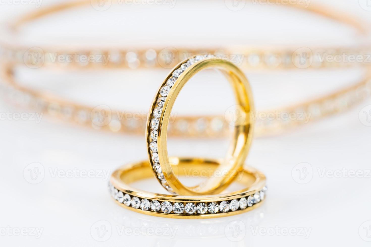 Gold wedding rings on white background photo