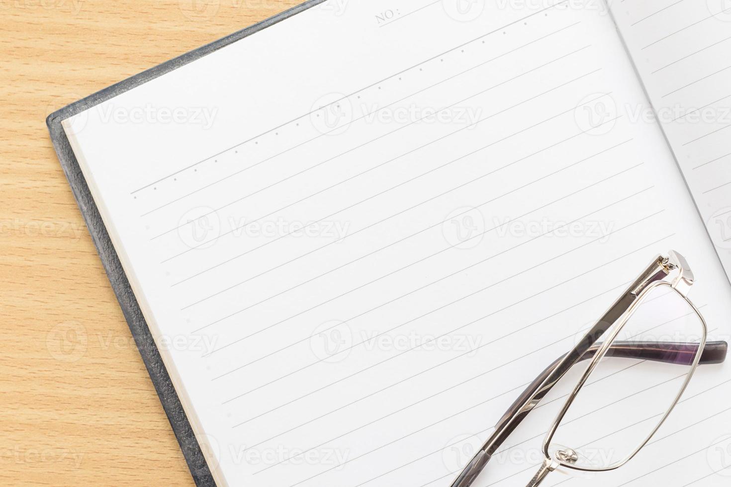 Notebook open blank page and Eyeglasses photo