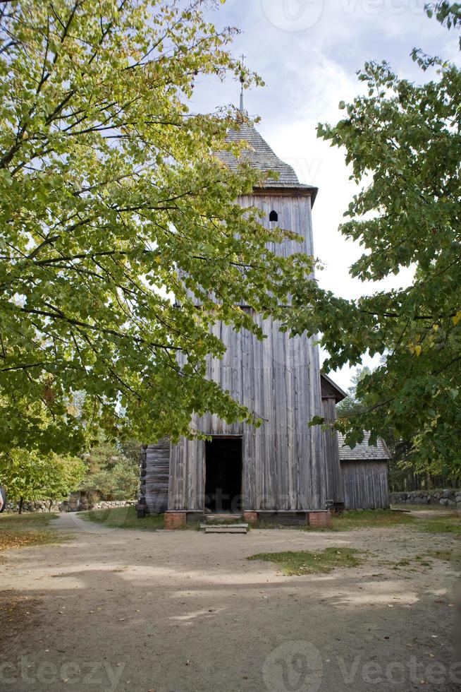 historic wooden church among autumn trees in Poland photo