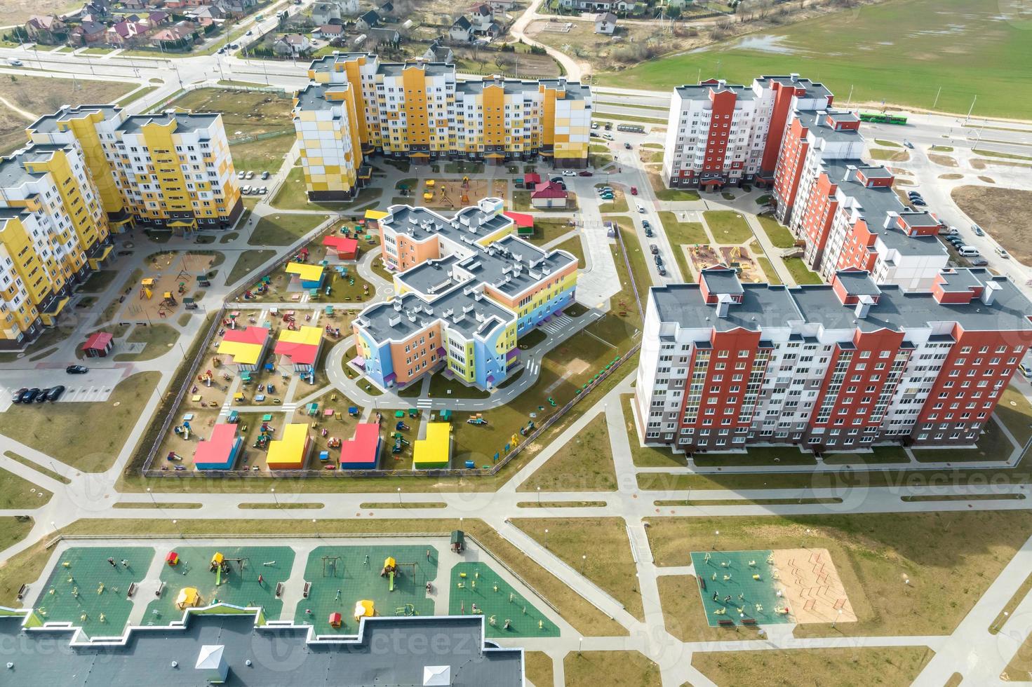 aerial panoramic view over construction of new modern residential complex with high-rise buildings in town photo