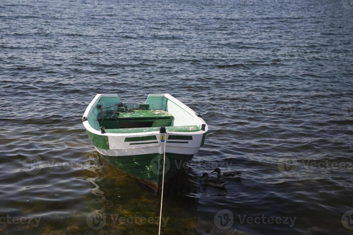 empty rowing boat on the water on a summer day photo