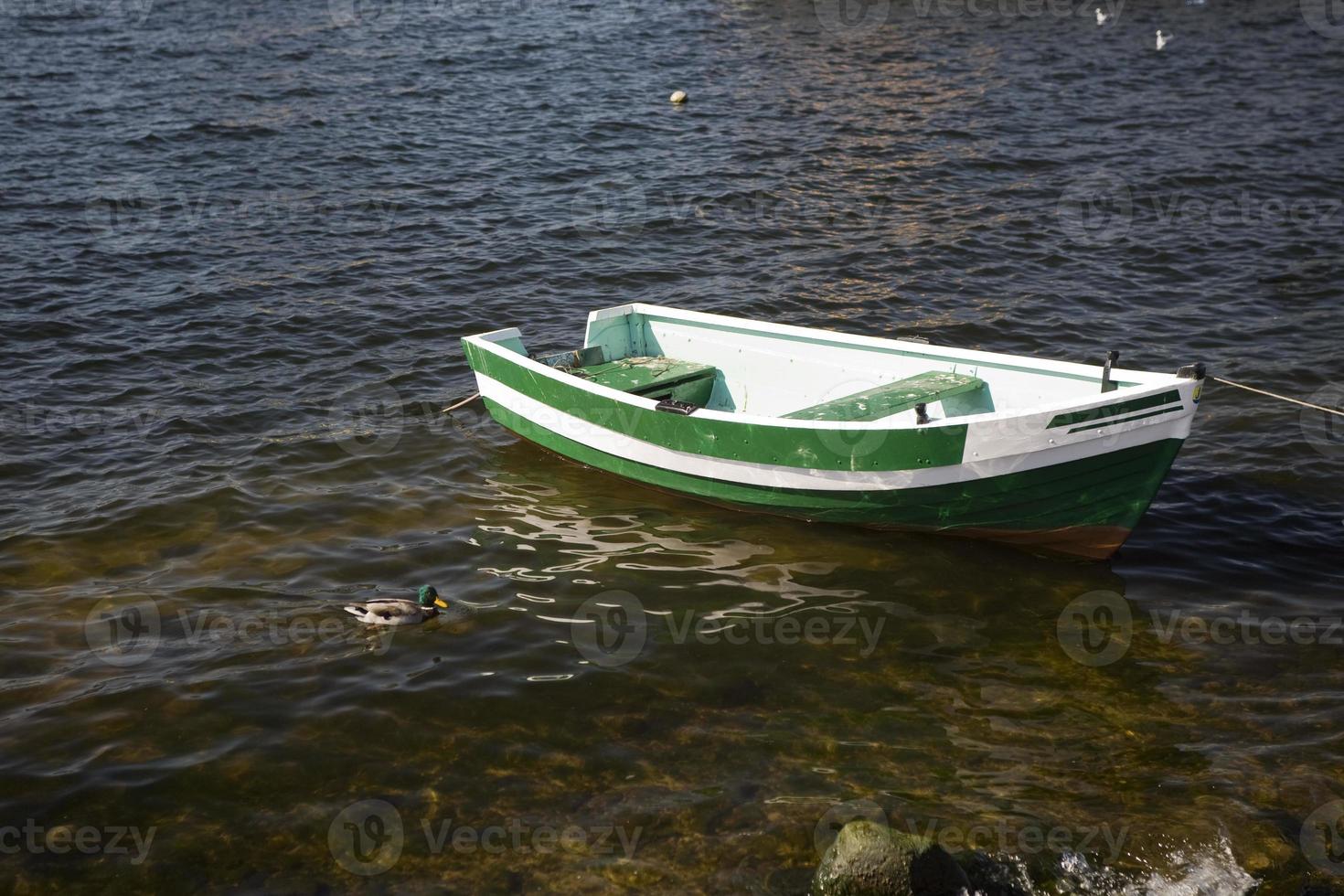 empty rowing boat on the water on a summer day photo