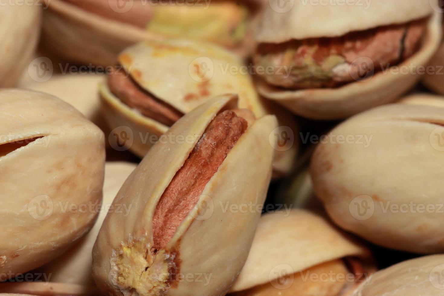 Pistachios macro on texture background. Tasty pistachios as background photo