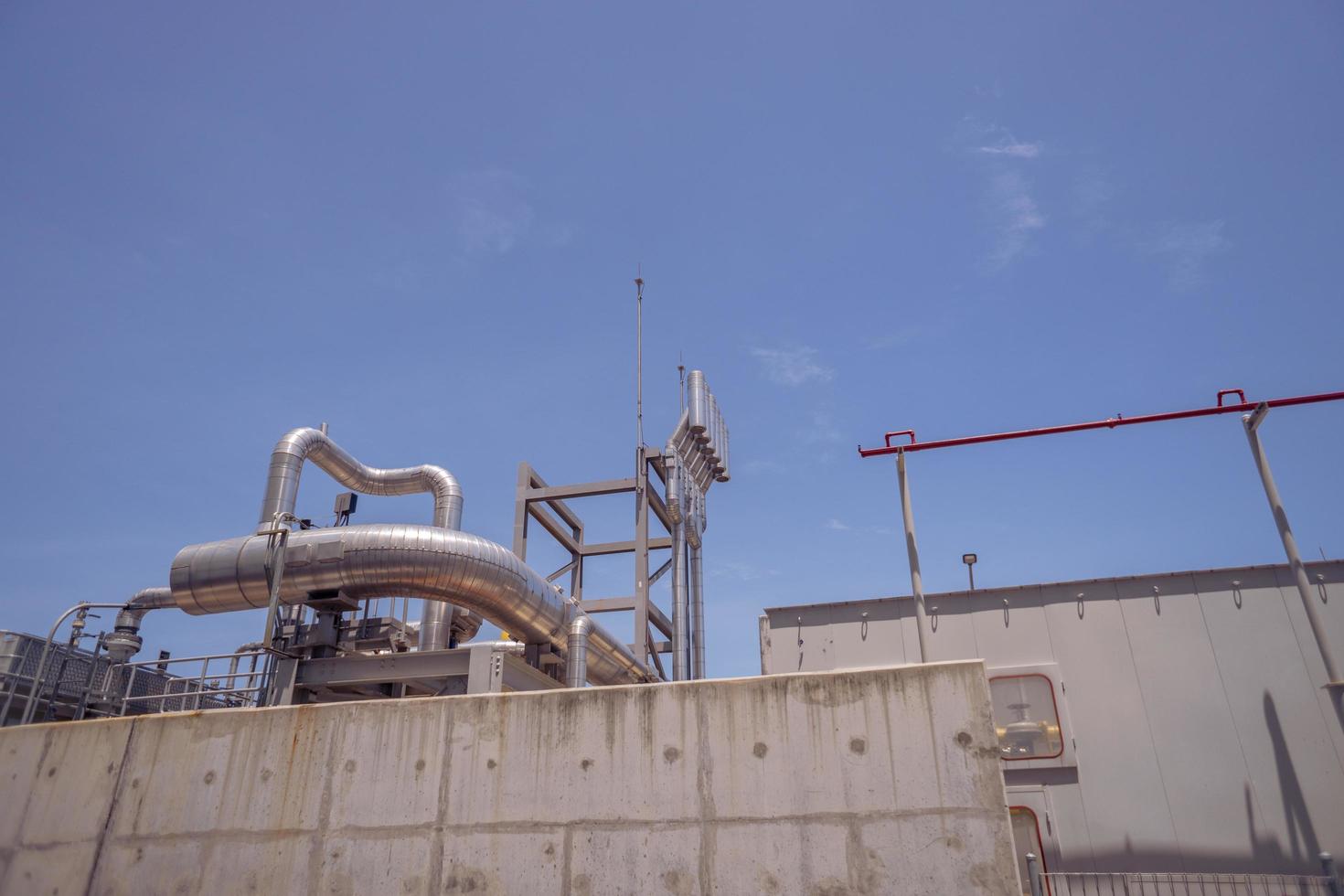 aerial view of combine cycle project power plant when day time with blue sky and cloudy vibes. The photo is suitable to use for industry background photography, power plant poster and electricity.