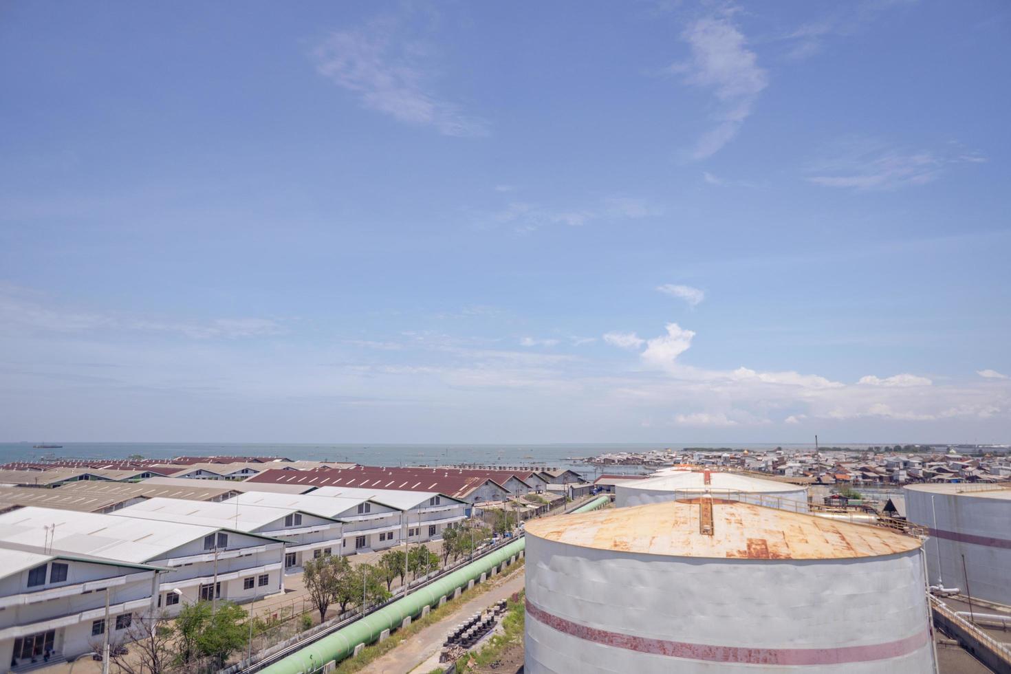 Arial view of power plant project with blue sky and cloudy vibes. The photo is suitable to use for industry background photography, power plant poster and electricity content media.