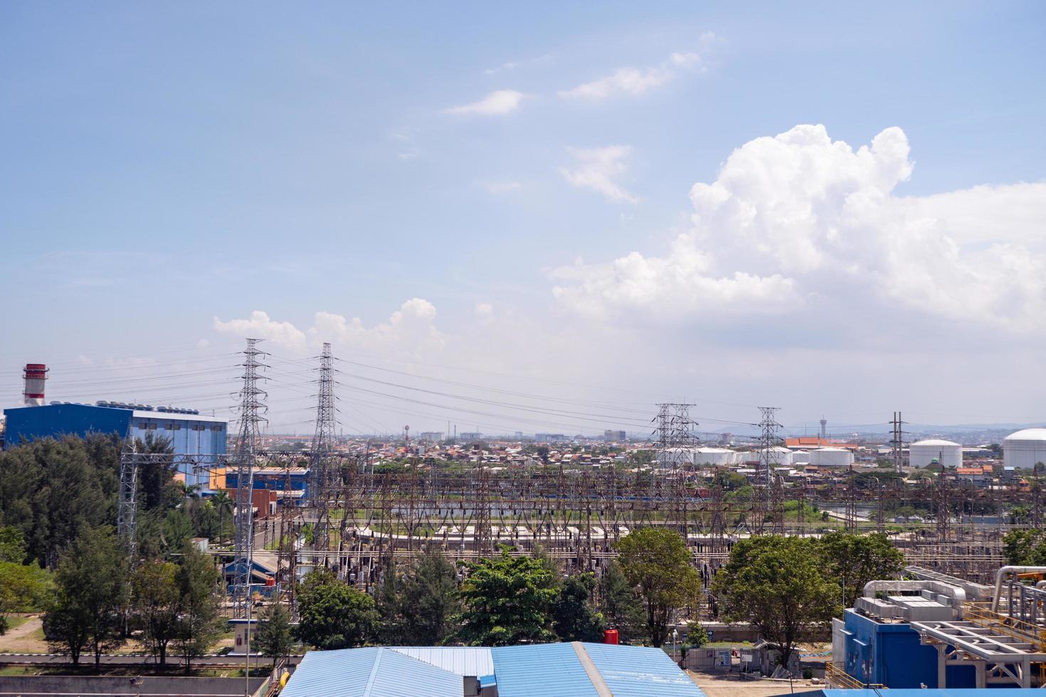 Arial view of power plant project with blue sky and cloudy vibes. The photo is suitable to use for industry background photography, power plant poster and electricity content media.