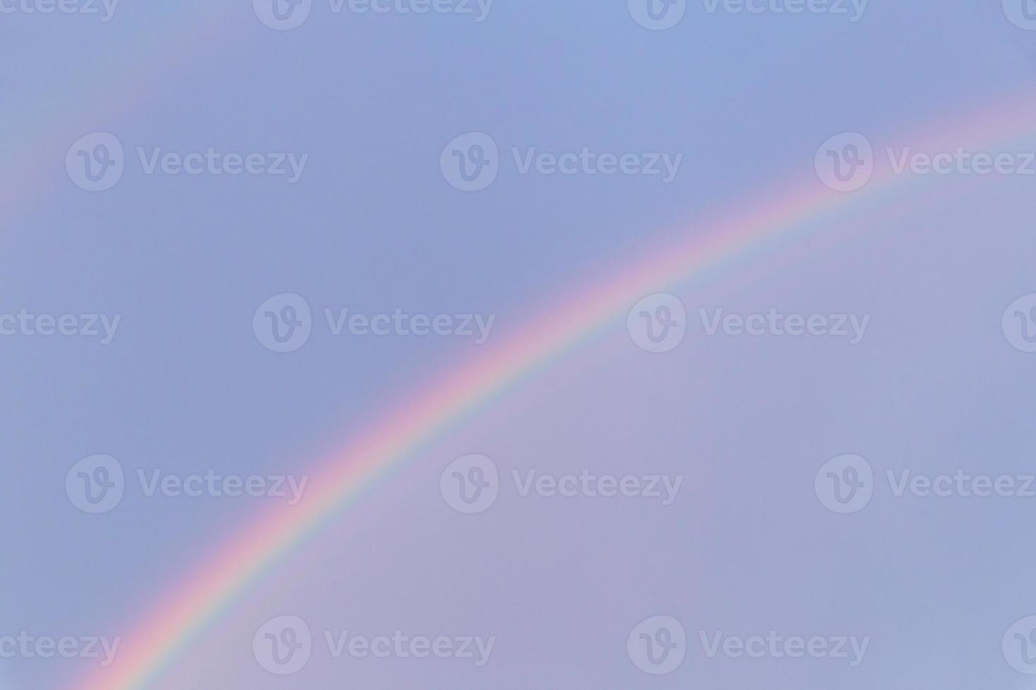view on rainbow in a blue sky photo