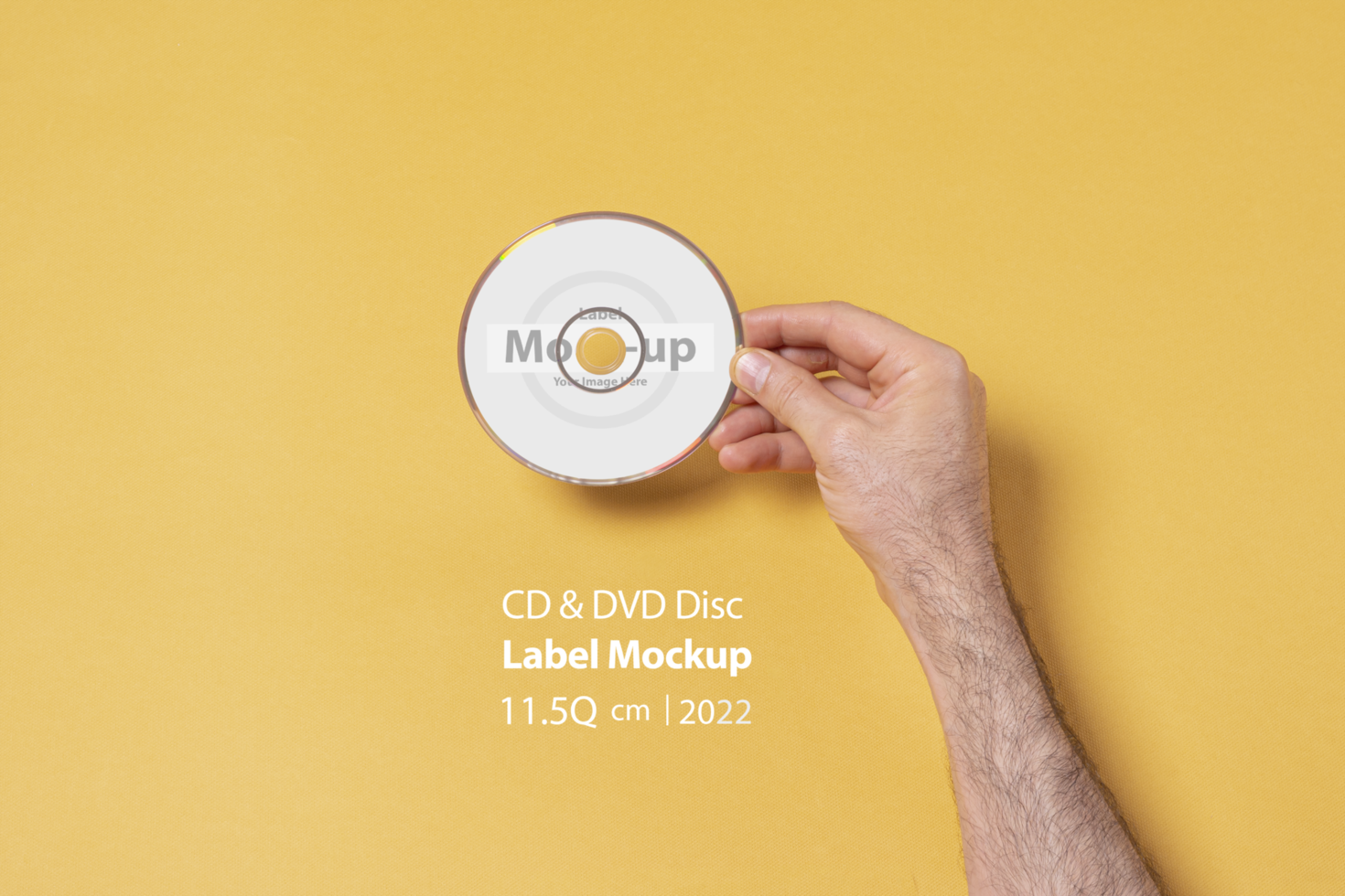 Male hand holding a CD-DVD disc in front of yellow background psd