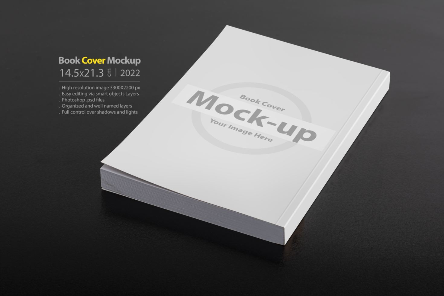 Book with blank cover on dark glossy table psd