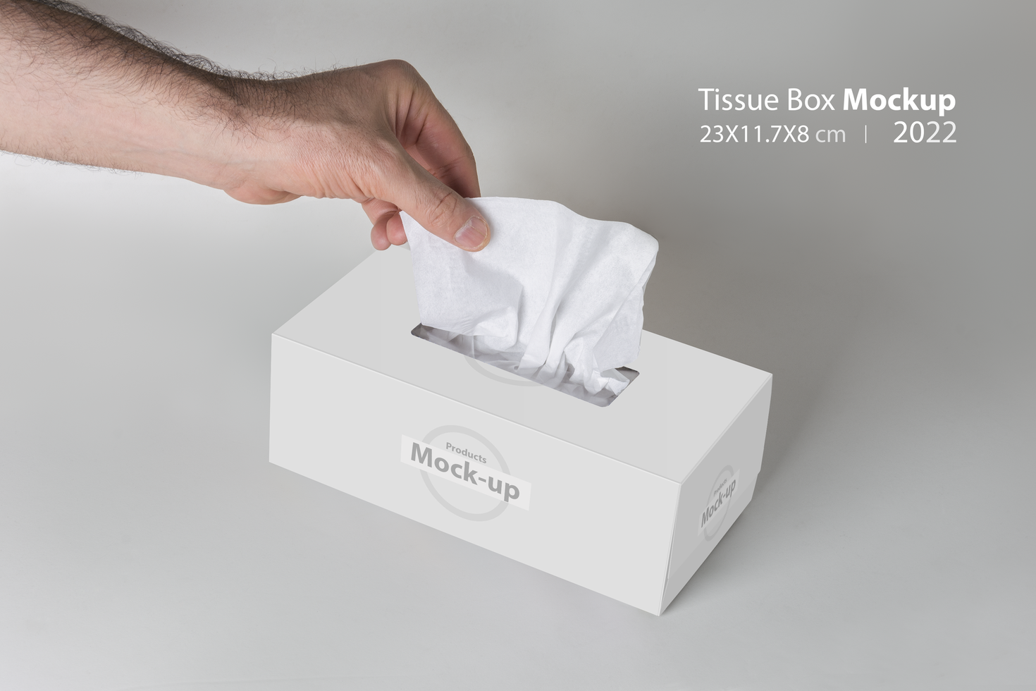 Men hand pulling a tissue from white tissue box on gray background psd