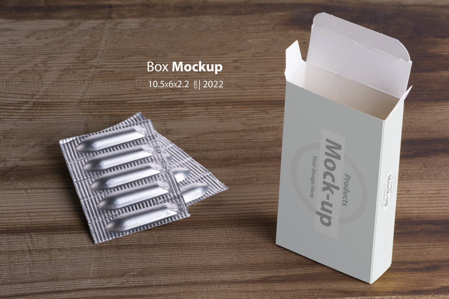 Suppositories loafs and an empty box on wooden table background psd