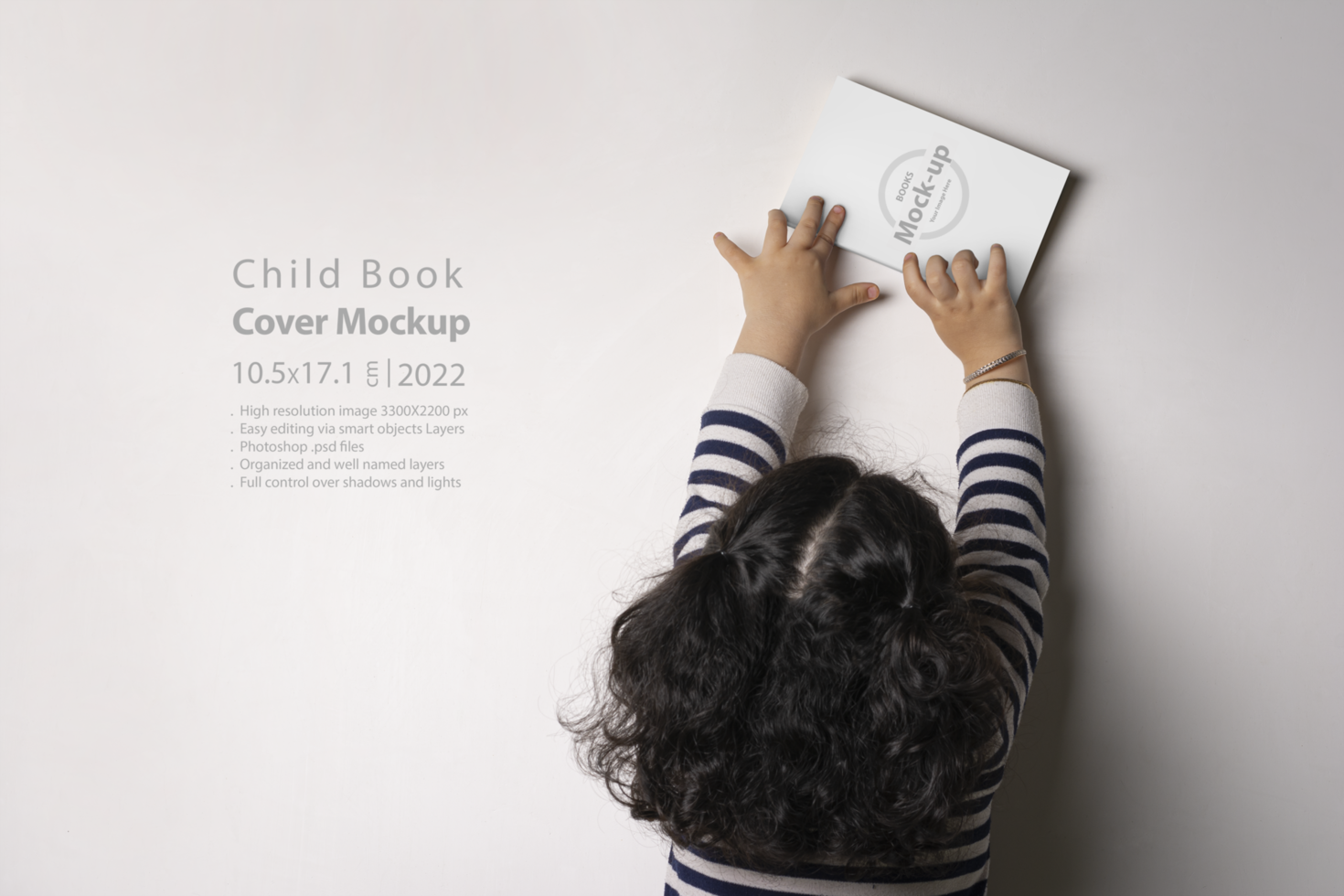 Little girl trying to put a novel book with blank cover at library psd