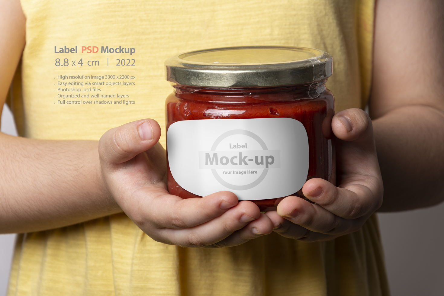 Homemade tomato paste in glass jar in little girl hands psd