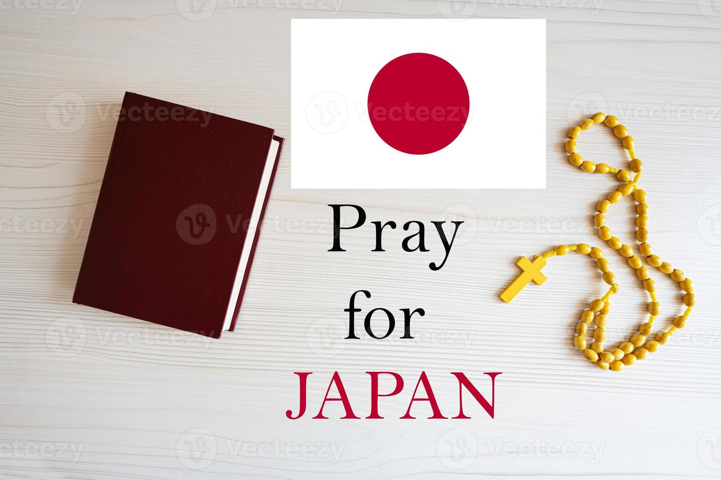 Pray for Japan. Rosary and Holy Bible background. photo