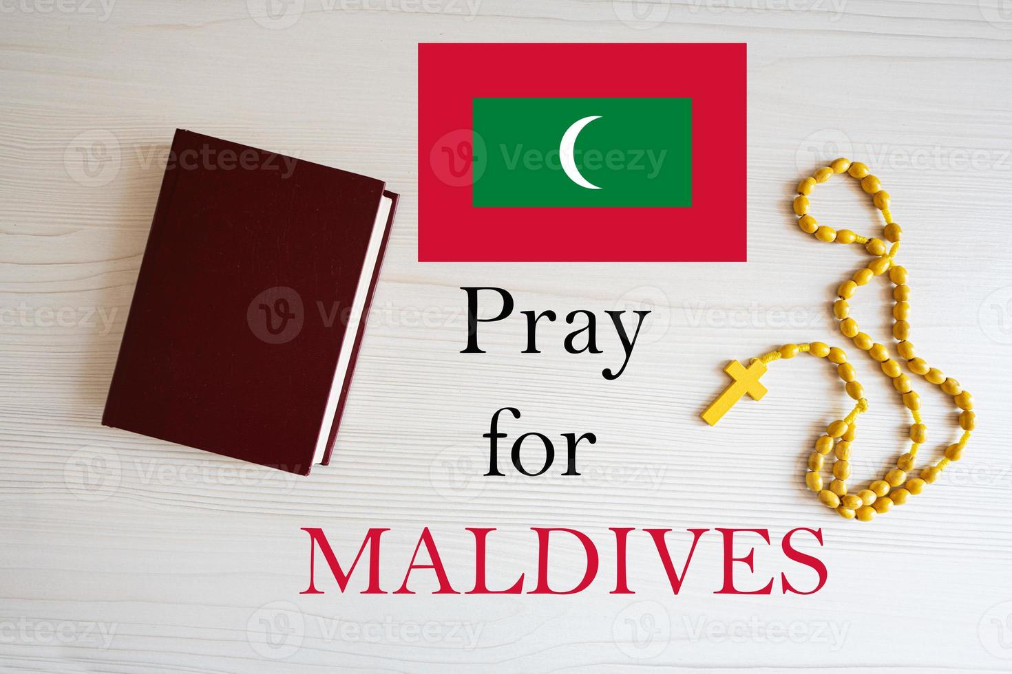 Pray for Maldives. Rosary and Holy Bible background. photo