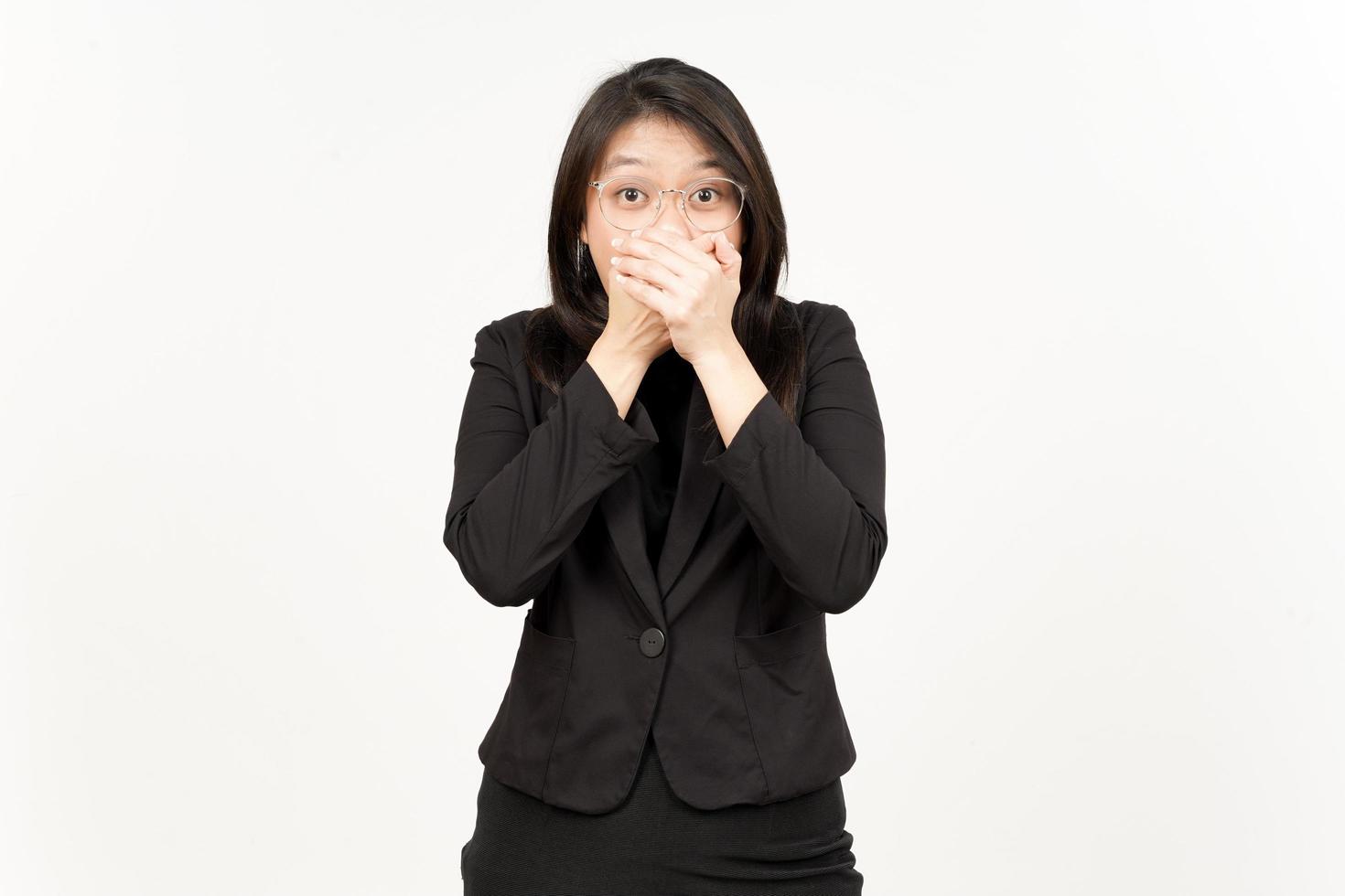 Shocked and Covering Mouth Of Beautiful Asian Woman Wearing Black Blazer Isolated On White photo