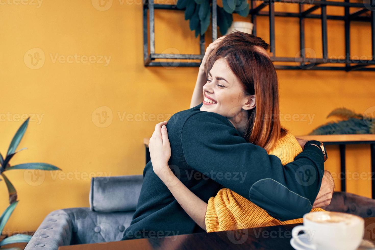 young couple sitting in a restaurant chatting dating photo