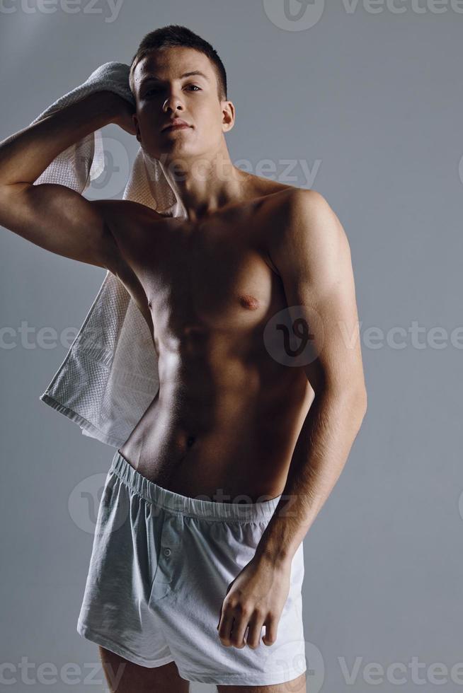 athlete with inflated torso holding a towel on his shoulder cropped view photo
