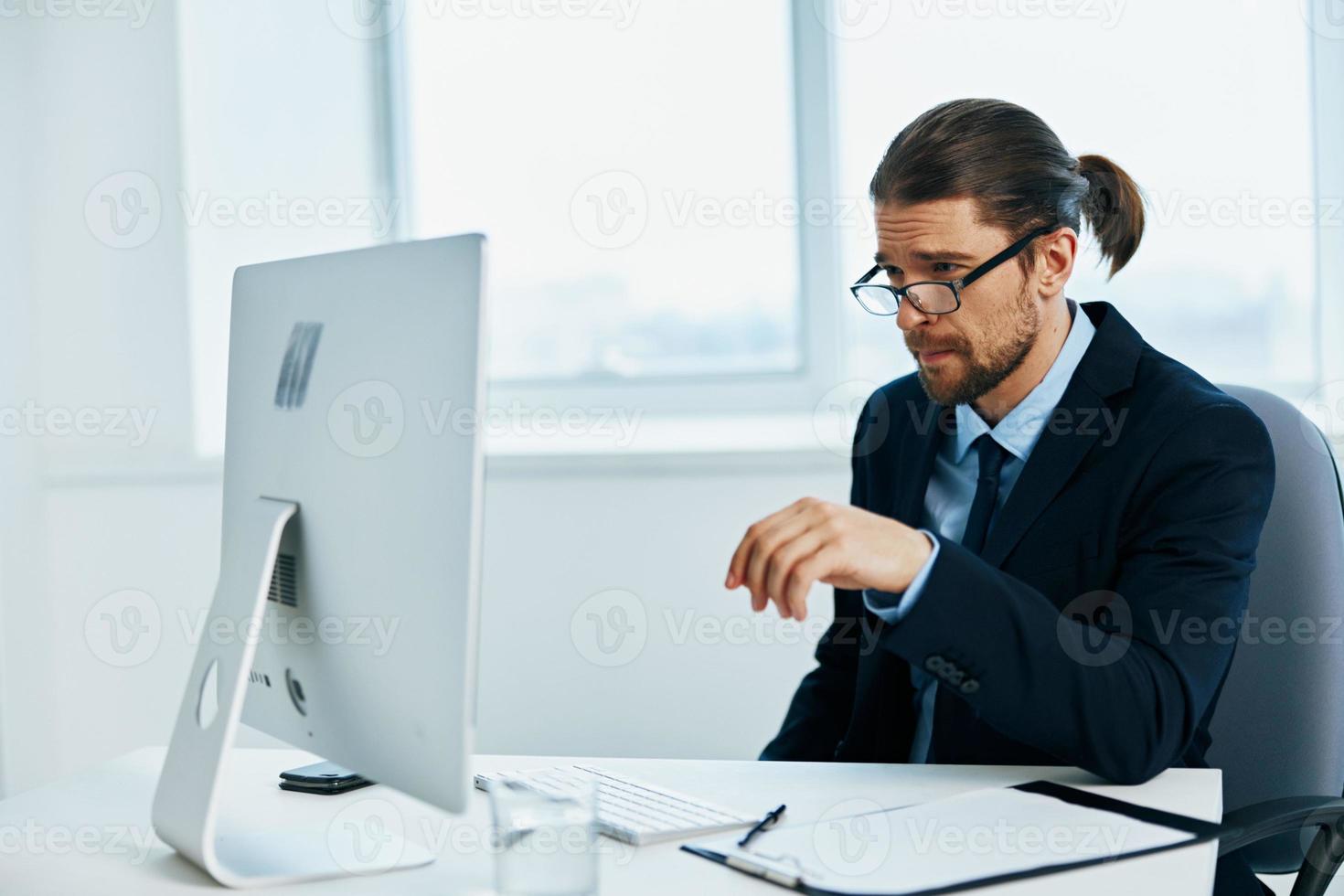 male manager at the desk with glasses work technologies photo