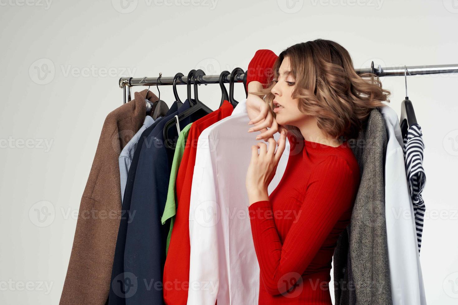 pretty woman trying on clothes shop shopaholic light background photo